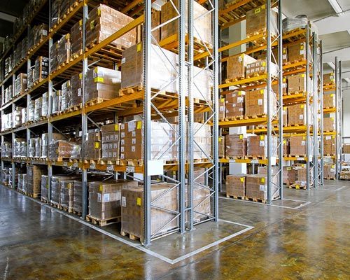 warehouse with four fully-stocked floor-to-ceiling shelves